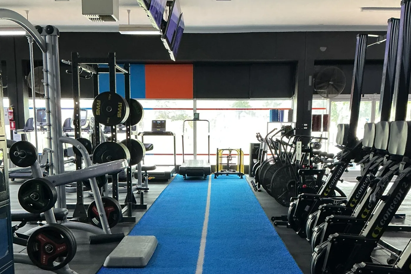 The Renmark floor, with a blue sled track running down the middle and rowing and ski machines alongside it